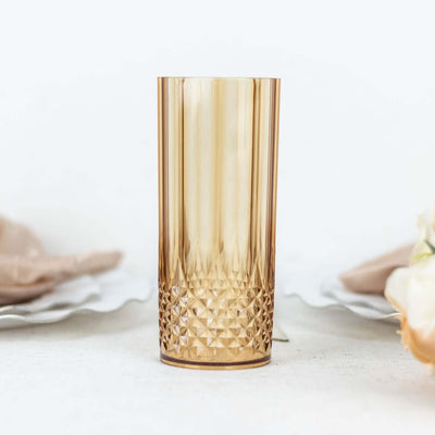 Amber textured glass tumbler on a plain background.