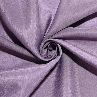 Purple fabric in a swirling pattern showcasing its texture and sheen.