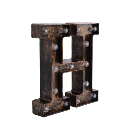 Vintage illuminated letter "H" decor with bulbs, rustic finish.