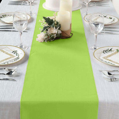 Bright green table runner on a dining table set with elegant tableware.