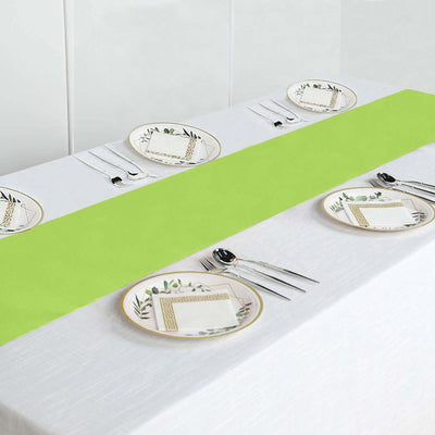 Table set with green runner and decorative plates for dining.