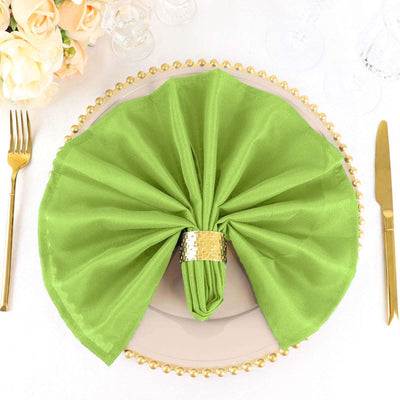 Green napkin elegantly arranged on a decorative plate with gold accents.