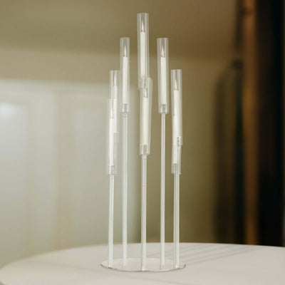 Modern clear candle holder with multiple tapered candles.