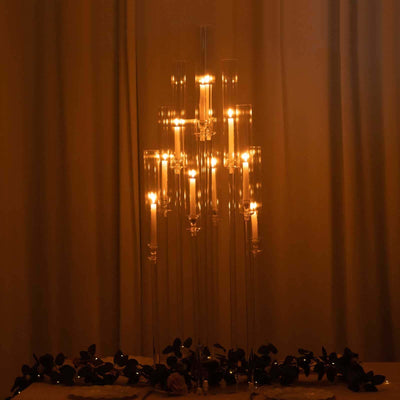 Elegant candle holder with candles softly illuminated in a dim setting.