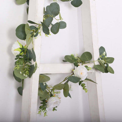 Artificial floral arrangement on a wooden ladder.