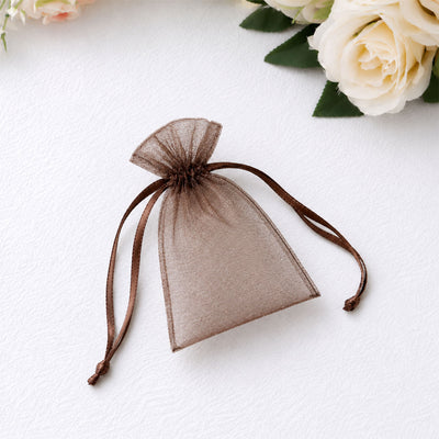 Brown organza drawstring gift pouch on white background with flowers