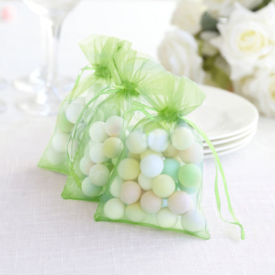 Green organza bags filled with pastel-colored decorative balls