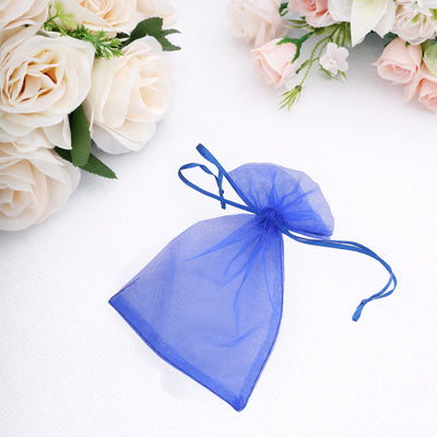 Blue organza drawstring bag on a white background