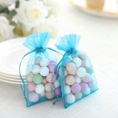 Colorful pastel decorative balls in blue organza bags.