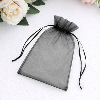 Black organza drawstring pouch on a white background.
