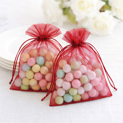 Colorful candy-filled organza bags for party favors.