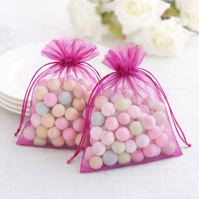 Colorful candy-filled organza bags in pink and pastel shades.