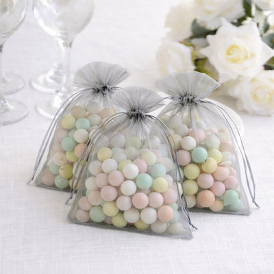 Pastel candy-filled favor bags in sheer gray pouches