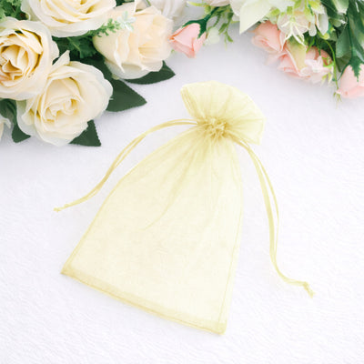 Yellow organza gift bag on white background