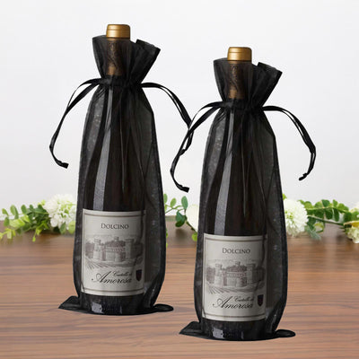 Dolcino wine bottles in elegant black sheer bags on a wooden surface.