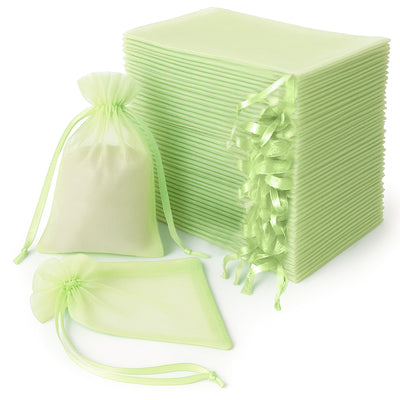 Stack of light green organza bags and sheets for gift wrapping