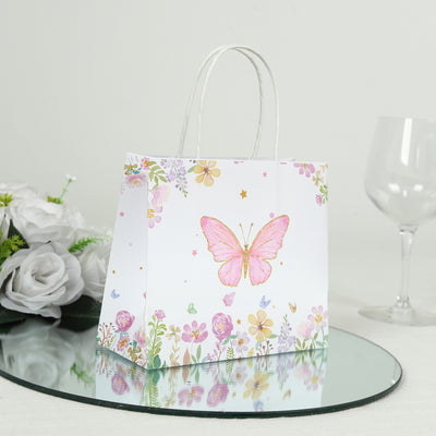 Decorative gift bag with butterfly and floral design on a reflective surface.