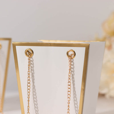 Elegant white gift bag with gold accents and chain handles