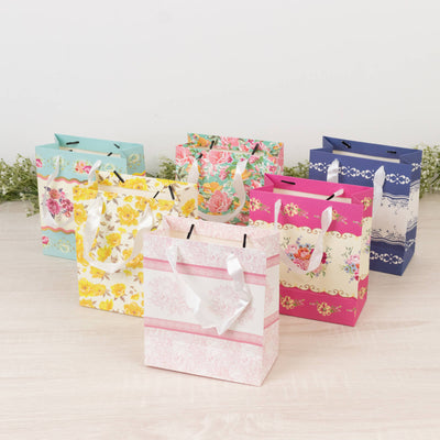 Colorful decorative gift bags in various floral designs arranged together.