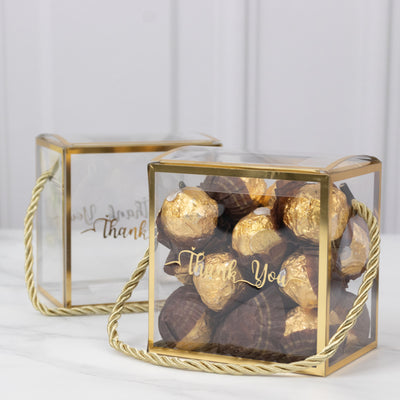 Clear gift boxes filled with chocolates, featuring a "Thank You" message.