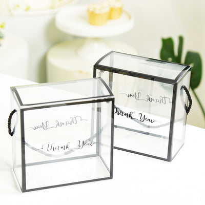 Clear gift boxes with \"Thank You\" design, featuring black trim and handles.