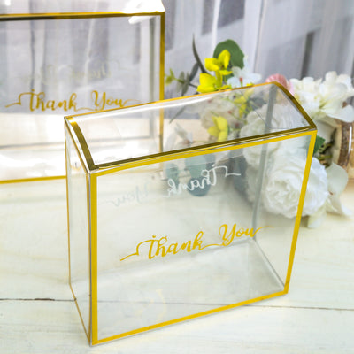 Clear acrylic box with gold "Thank You" text on a neutral background.