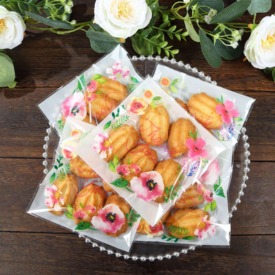 Assorted floral-packaged mini cakes on a decorative tray.