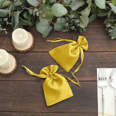 Yellow satin drawstring bags with a rustic table setting.