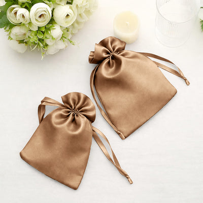 Two elegant satin drawstring bags in bronze color.
