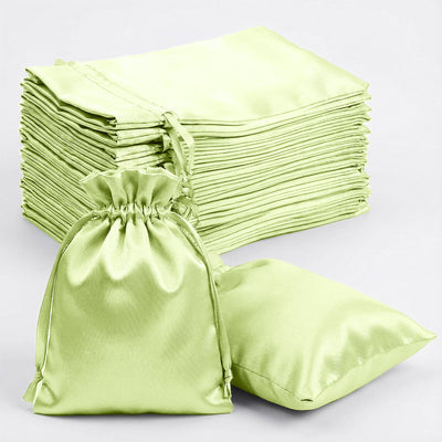 Set of green satin bags and cushions for storage and decoration
