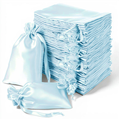 Stack of light blue satin drawstring bags on a white background