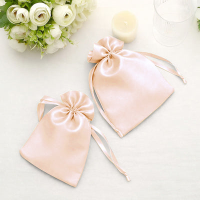 Silk drawstring bags in soft pink color on a light background