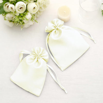 White satin favor bags with ribbon ties for weddings or events