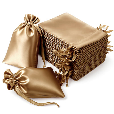 Gold satin gift bags and pouches stacked elegantly.