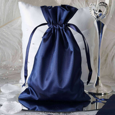 Navy satin drawstring bag on a reflective surface with decorative elements.