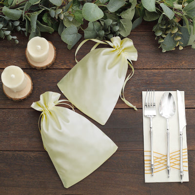 Elegant satin gift bags in soft green with ribbons, perfect for special occasions.