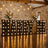 Illuminated “MARRY ME” sign with wedding floral arrangements in rustic venue