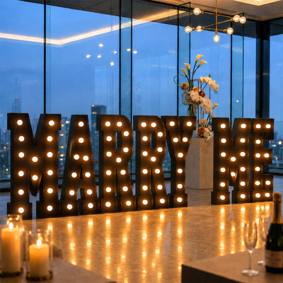 Marquee “MARRY ME” wedding proposal sign in a luxury skyline venue