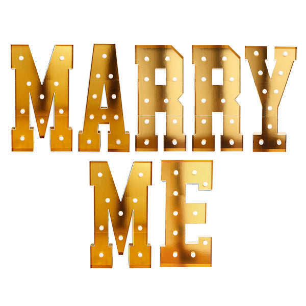 Gold “Marry Me” marquee letters with light bulbs on a white background#whtbkgd