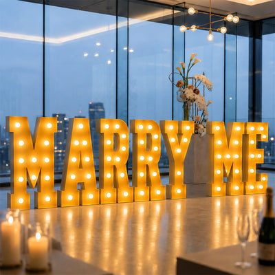 Illuminated “MARRY ME” proposal sign in a modern rooftop venue