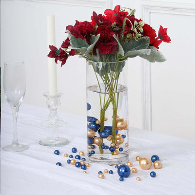 Floral arrangement in a vase with decorative beads on a table setting.