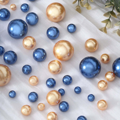 Colorful decorative pearls in blue and gold on a soft white background.