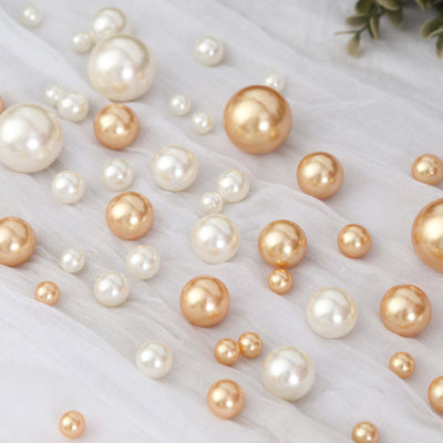 Assorted decorative pearls in gold and white on soft fabric.