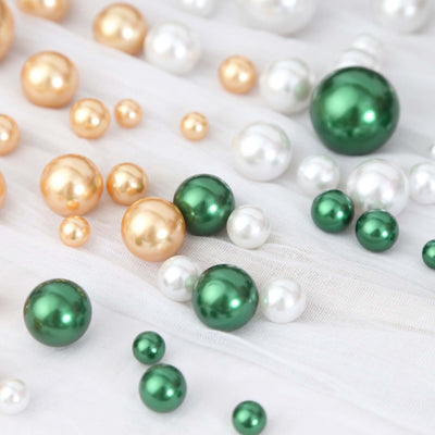 Colorful decorative pearls in various sizes on a soft fabric background.