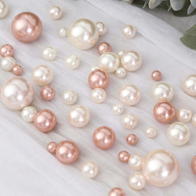 Assorted pink and white decorative pearls on soft fabric.