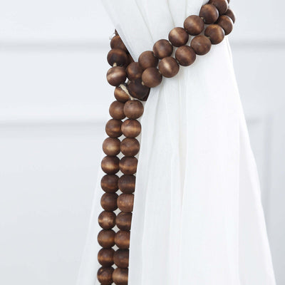 Wooden bead curtain tieback on white fabric