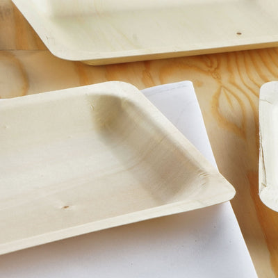 Natural wood serving trays on a wooden surface.