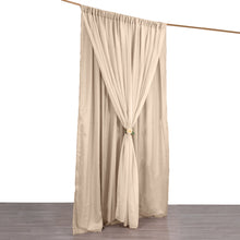 A solid nude chiffon and polyester curtain is hanging on a wooden pole, perfect for room divider, paired with our backdrop stands.