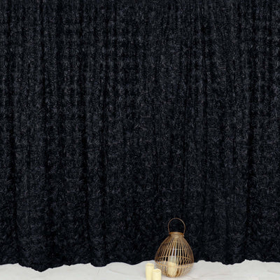 Black textured curtain with gold decorative lantern and candles in front.