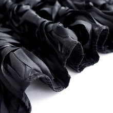 A close up of a black satin 3D Rosette backdrop curtain on a white background